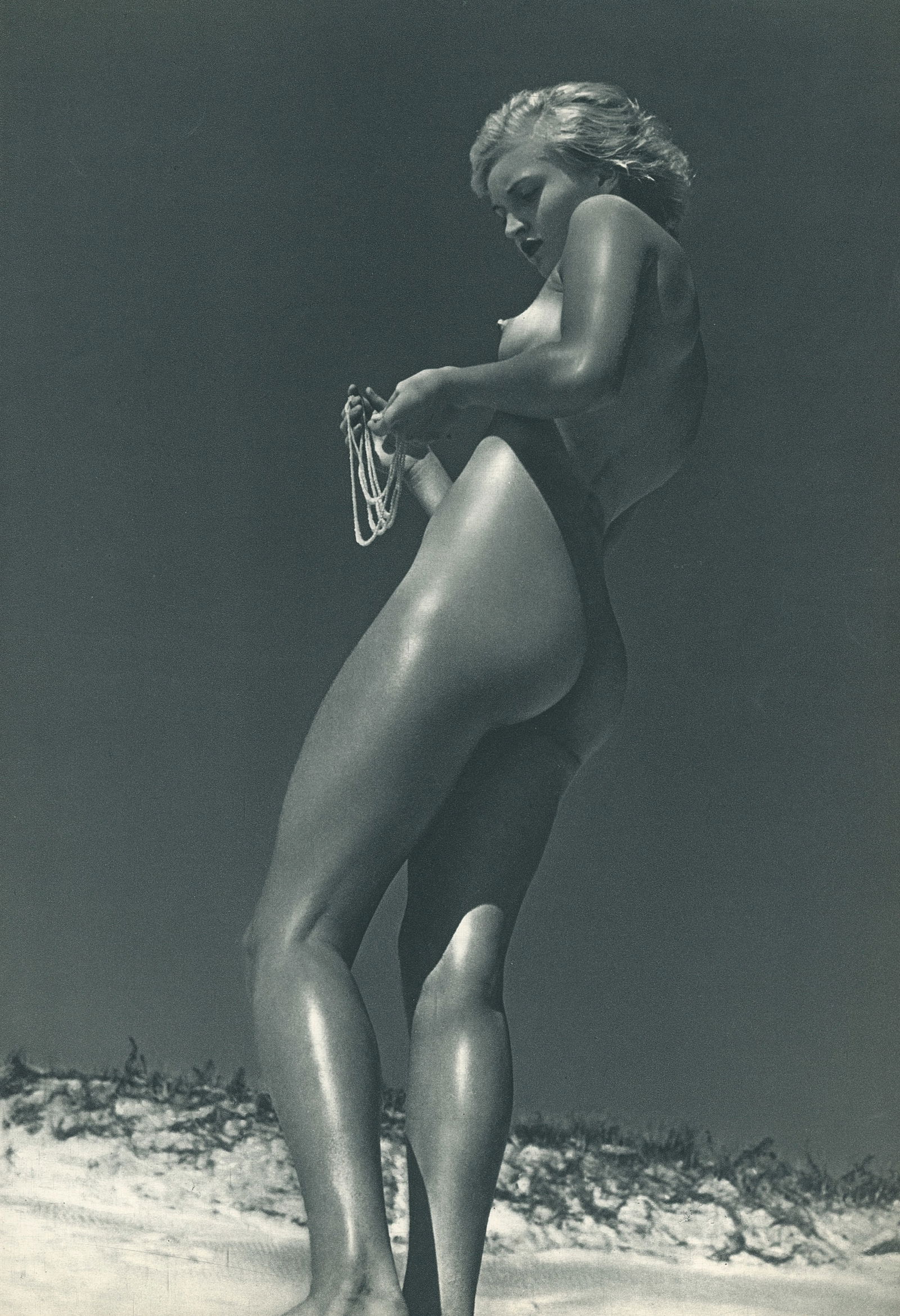 Nude by Andre Dienes. C1959: Nude by Andre de Dienes. (1913 - 1985). American-Hungarian photographer famous for nude photography and photographs of a young Marilyn Monroe. 11.75 x 8 in. Reverse: 11.75 x 8 in.