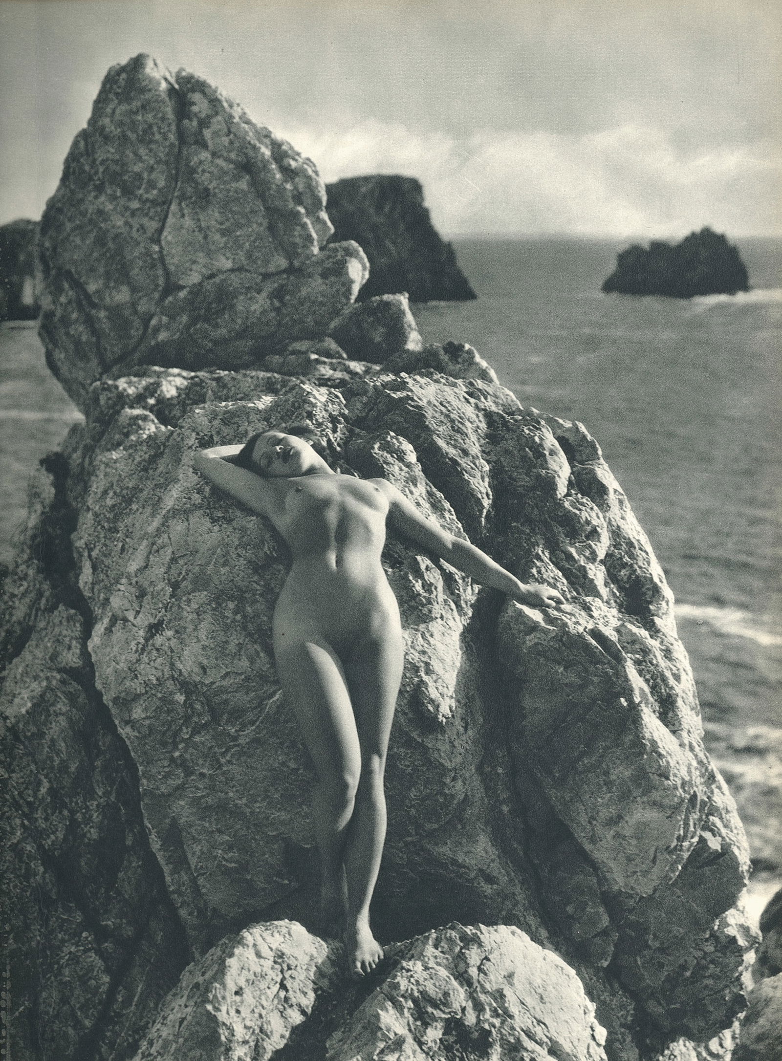 Nude by George Louis Arlaud. C1936: G.L. Arlaud (1869 - 1944) was a French photographer known for his outdoor nude studies he took in the South of France. He settled in La Ciotat in 1942, where he was assassinated in 1944, the day after