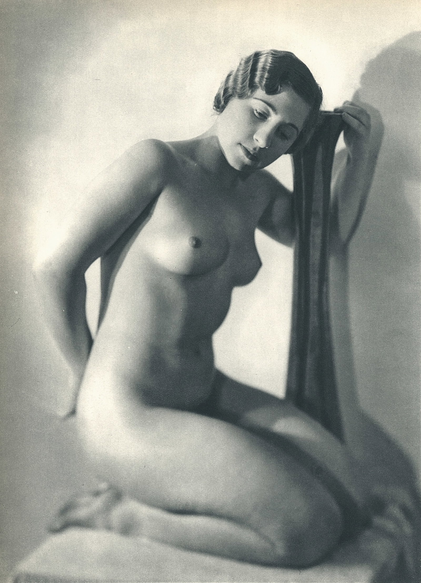 Nude by George Louis Arlaud. C1936: G.L. Arlaud (1869 - 1944) was a French photographer known for his outdoor nude studies he took in the South of France. He settled in La Ciotat in 1942, where he was assassinated in 1944, the day after