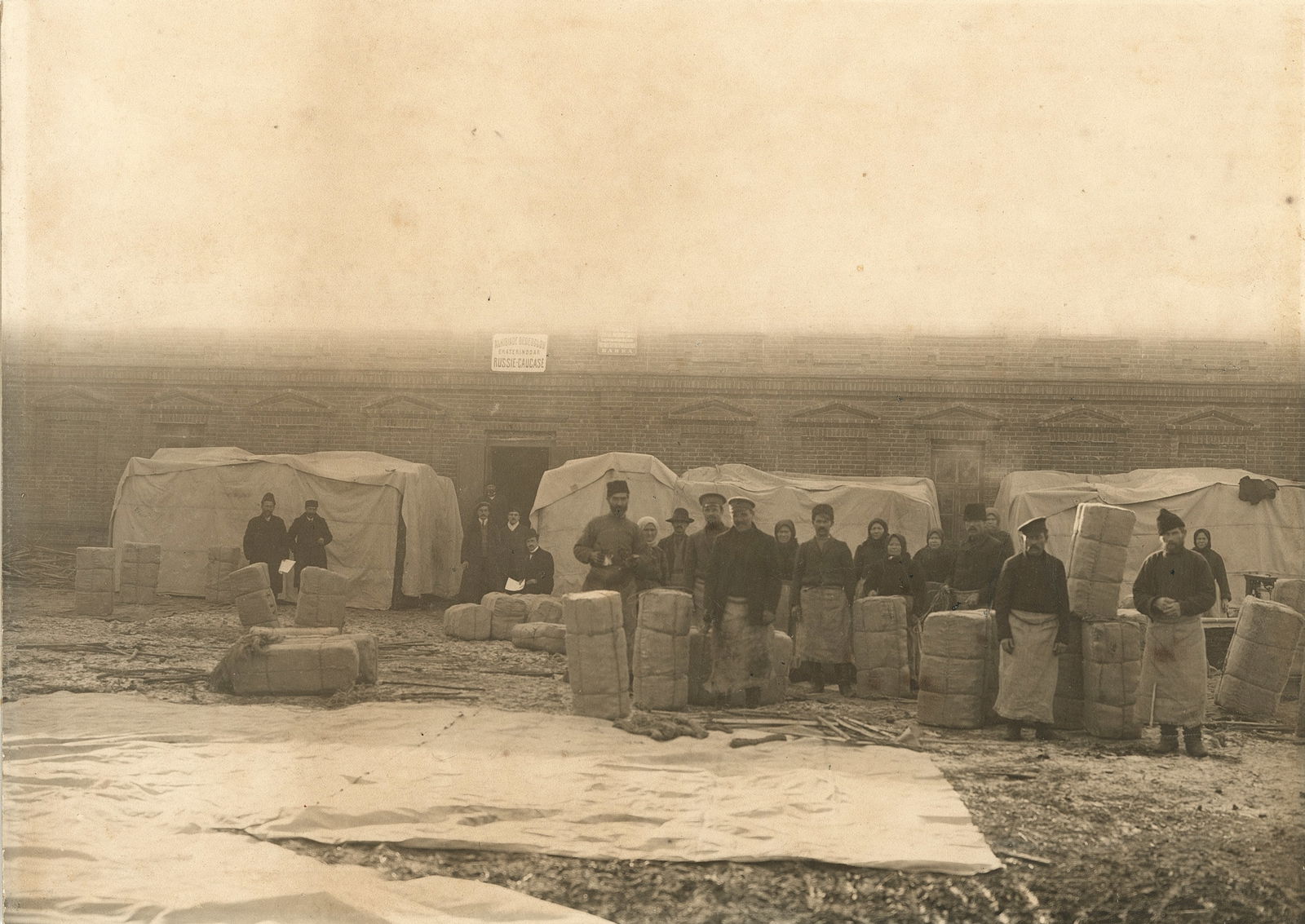 Workers in the Russian Caucasus Factory. c1910: Workers in the Russian Caucasus Factory. C1910. Sign reads: Ekaterndoar, Russie Caucase with an unreadable name above. Fair to good contrast and tonality. 6.25 x 8 in