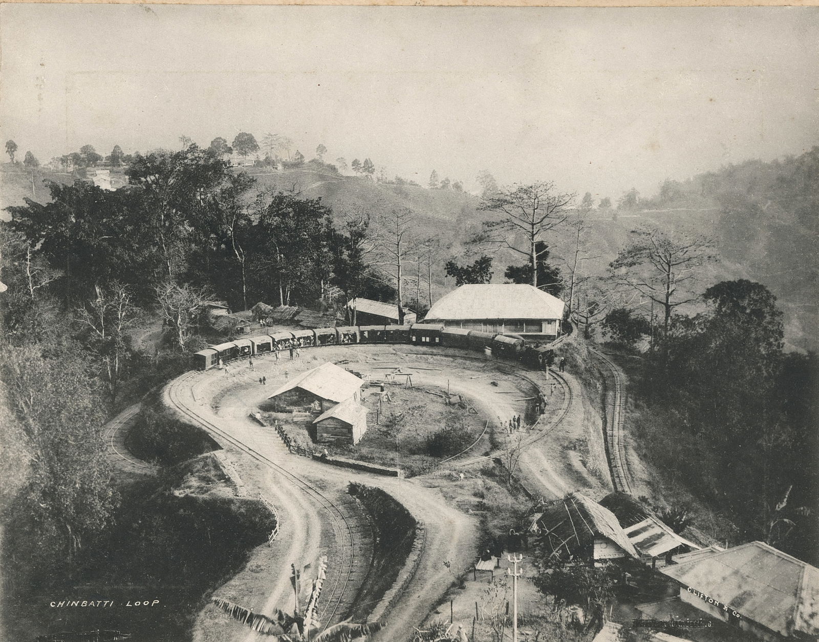 Collotype - Double Loop, Darjeeling - Himalayan Railway. c1900: Collotype - Double Loop, Darjeeling - Himalayan Railway. C1900 By Clifton and Co. 7.5 x 9.5 in. Reverse: Darjeeling, General view of Kinchinjunga. 6.375 x 9.25 in.