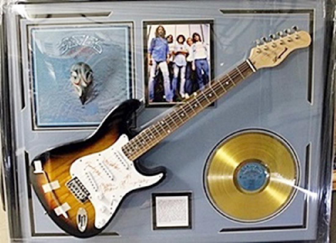 The Eagles Signed Guitar with Bio, Photo and Gold: The Eagles Guitar with Laser Matted Autographs. Approx. 35x42in.