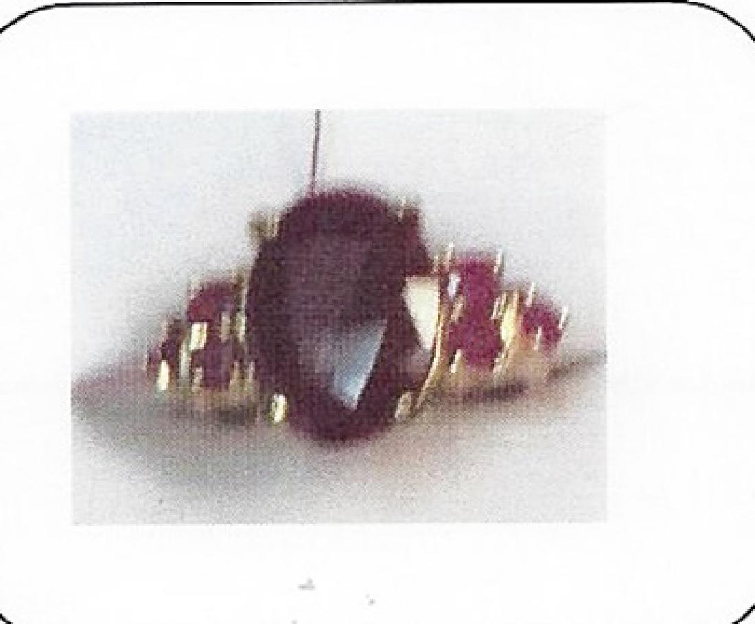 Lady's 10K yellow gold ruby ring: This lady 10K yellow gold ruby ring comprised of 4 prongs set oval cut ruby surrounded by 4 prongs set 6 round rubies. Total weight of the rubies are 3.85ctw the total weight of the ring is 4.51gms.