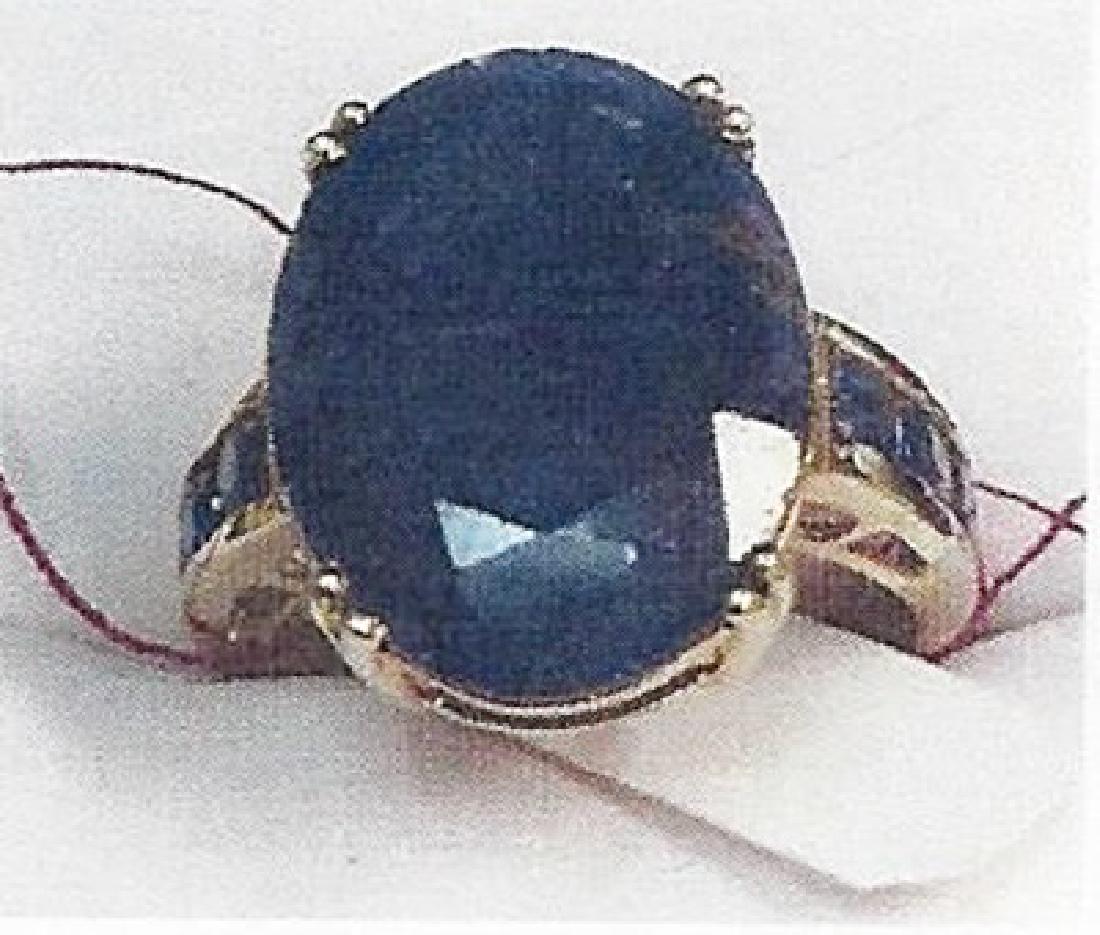 Lady's 10K yellow gold blue sapphire ring: This lady 10K yellow gold blue sapphire ring comprised of 4 prongs set oval cut blue sapphire surrounded by channel set 6 round sapphire. Total weight of the blue sapphire is 4.30cts the total weight