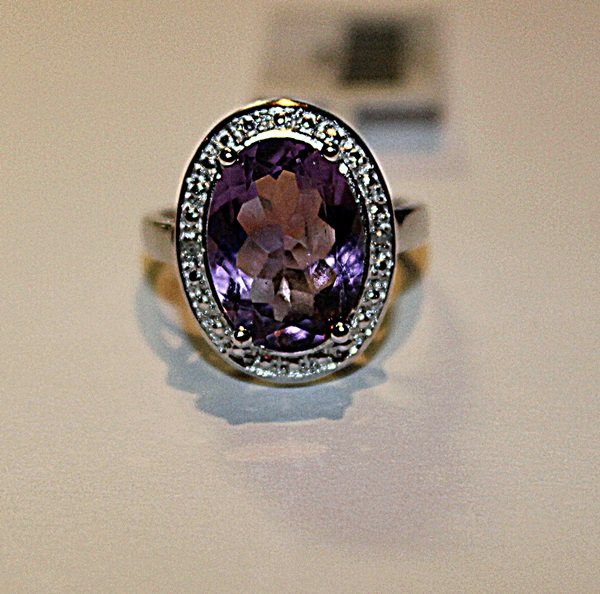 Beautiful Amethyst & Diamond Ring: Beautiful amethyst and diamond ring set in 925 sterling silver. The amethyst is approximately 8CT and diamonds are accent. The ring size is 7.
