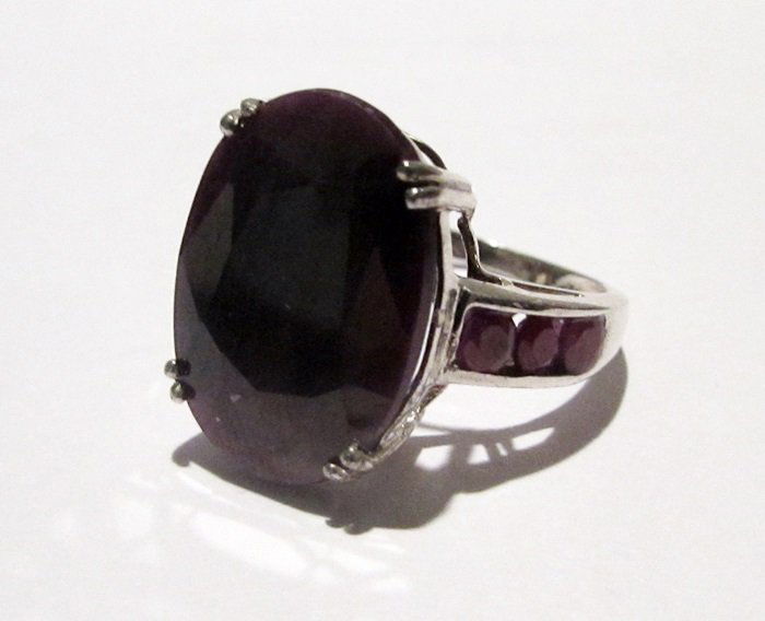 10K Yellow Gold Ruby Ring: This 10k yellow gold ruby ring is comprised of 4 prongs set oval cut ruby surrounded by channel set 6 round rubies. This estimated weight of the rubies are 4.85ctw. This estimated weight of the ring i