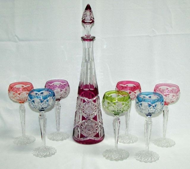 Eight Piece Val St. Lambert Crystal Saarbrucken Pattern: Saarbrucken Pattern. Comprising a decanter with stopper and seven wine hocks, variegated color cut to clear. Height - 14 inches, the hocks are 8 inches.