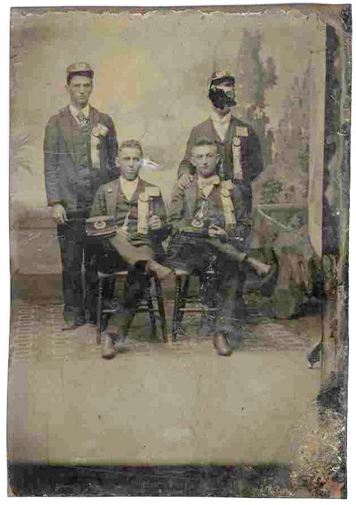 Civil War Tintype Union Soldiers Photograph Pic: CW tintype of four Union soldiers. Two are seated crosslegged, while two others stand behind them. One of the seated soldiers holds up a flag emblem with 13 stripes but only seven stars in the field,