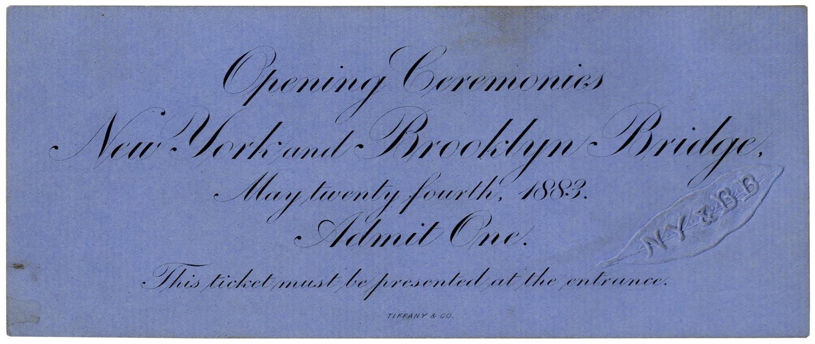 Ticket to the Brooklyn Bridge Opening Ceremonies: Brooklyn Bridge opening ceremonies ticket in deep periwinkle blue. Official ticket for the 24 May 1883 event features an embossed leaf design reading ''NY & BB'', referring to its original name, the '