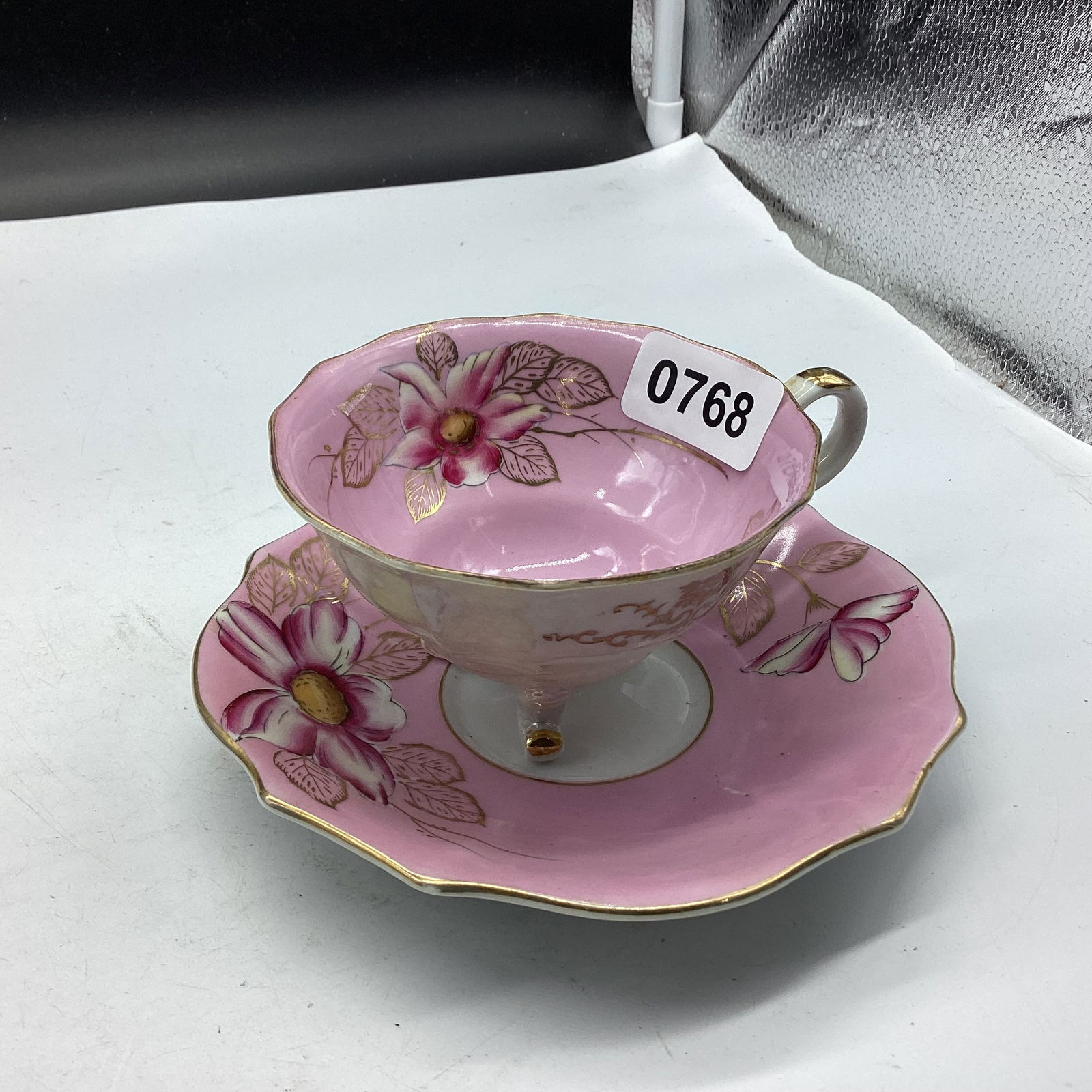 HAND PAINTED 3 FOOTED CUP & SAUCER (1 of 1)