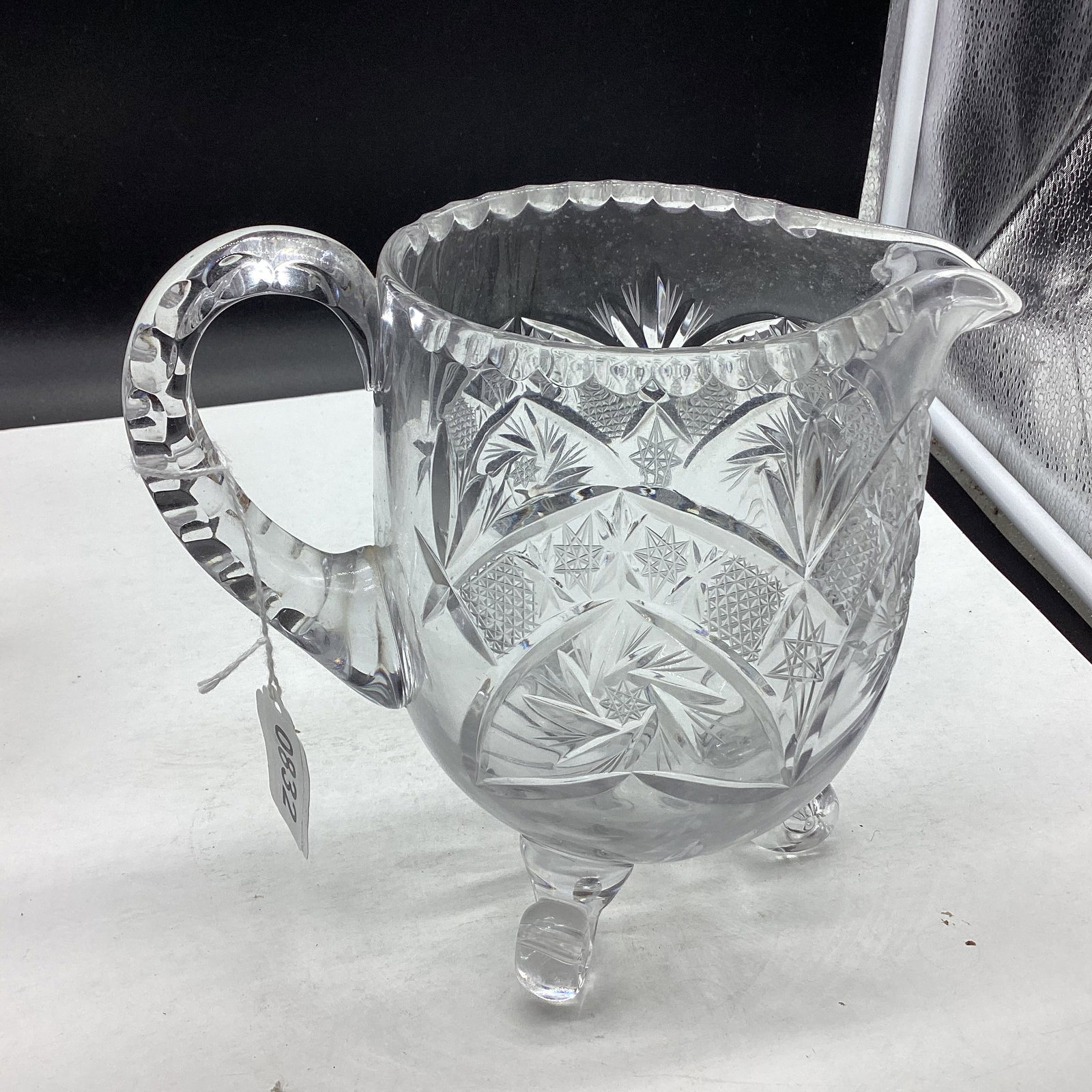 CUT GLASS 3 FOOTED JUICE PITCHER: 7 1/2" TALL GOOD SHAPE
