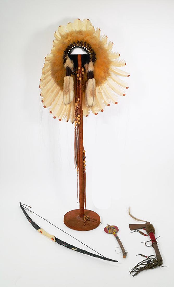 Native American Indian Chief Headdress and Weapons: Vintage Indian handmade beaded feather headdress and weapons, most likely made for affluent tourist market. Includes leather-wrapped headdress stand, tomahawk and bow.