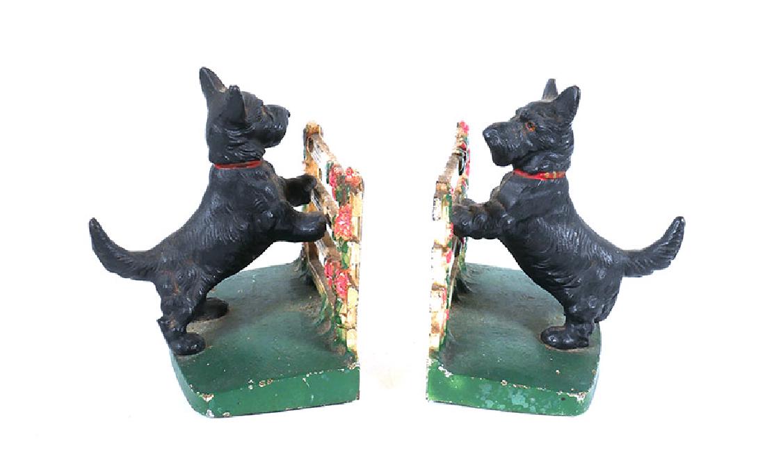 Pair Antique Hubley Scottish Terrier Bookends #430: Pair of Hubley cast iron bookends of Scottie dogs with front paws on a flowery fence. Original paint, measuring about 5" high. Minor paint loss, mostly along edges.