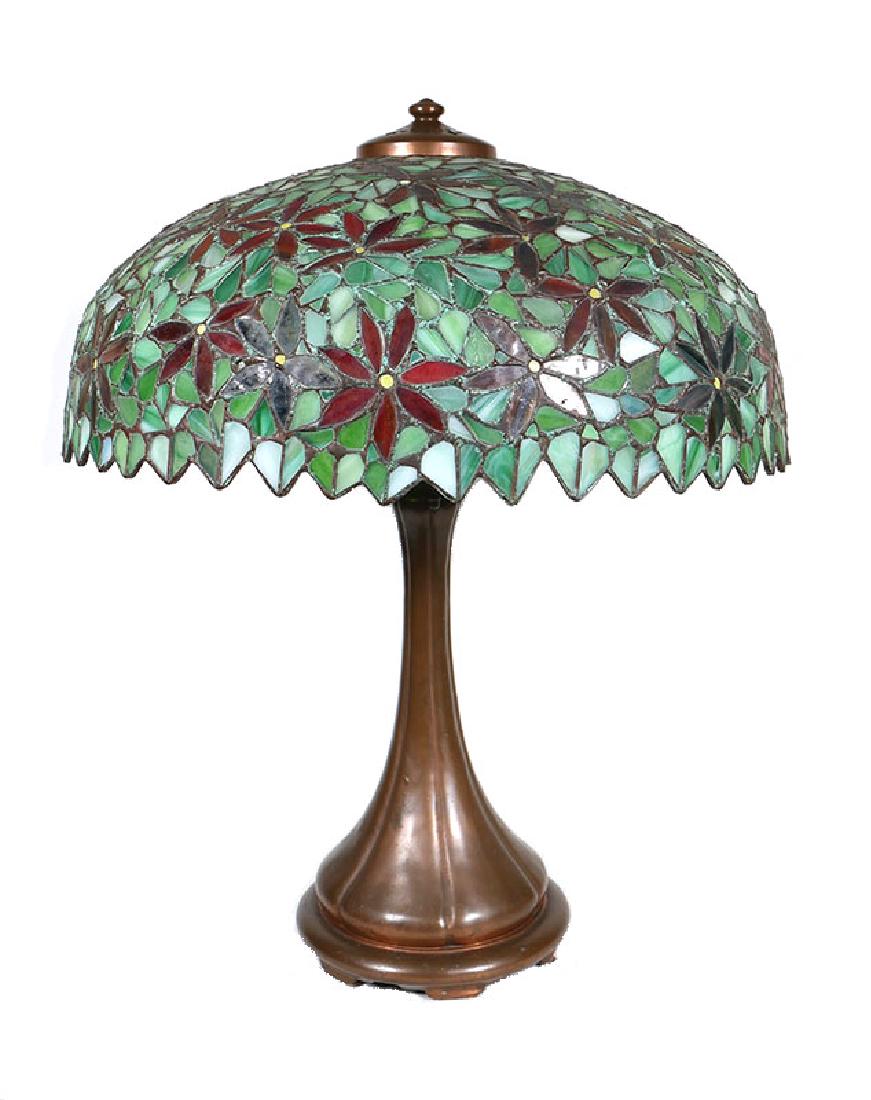 Handel Poinsettia Stained Glass Table Lamp: Gorgeous antique Handel lamp. Base stamped "HANDEL" near bottom. Unsigned shade as far as we can determine. Shade is in excellent condition. Shade measures 18-1/2" diameter and 7-1/2" deep. Lamp is 23