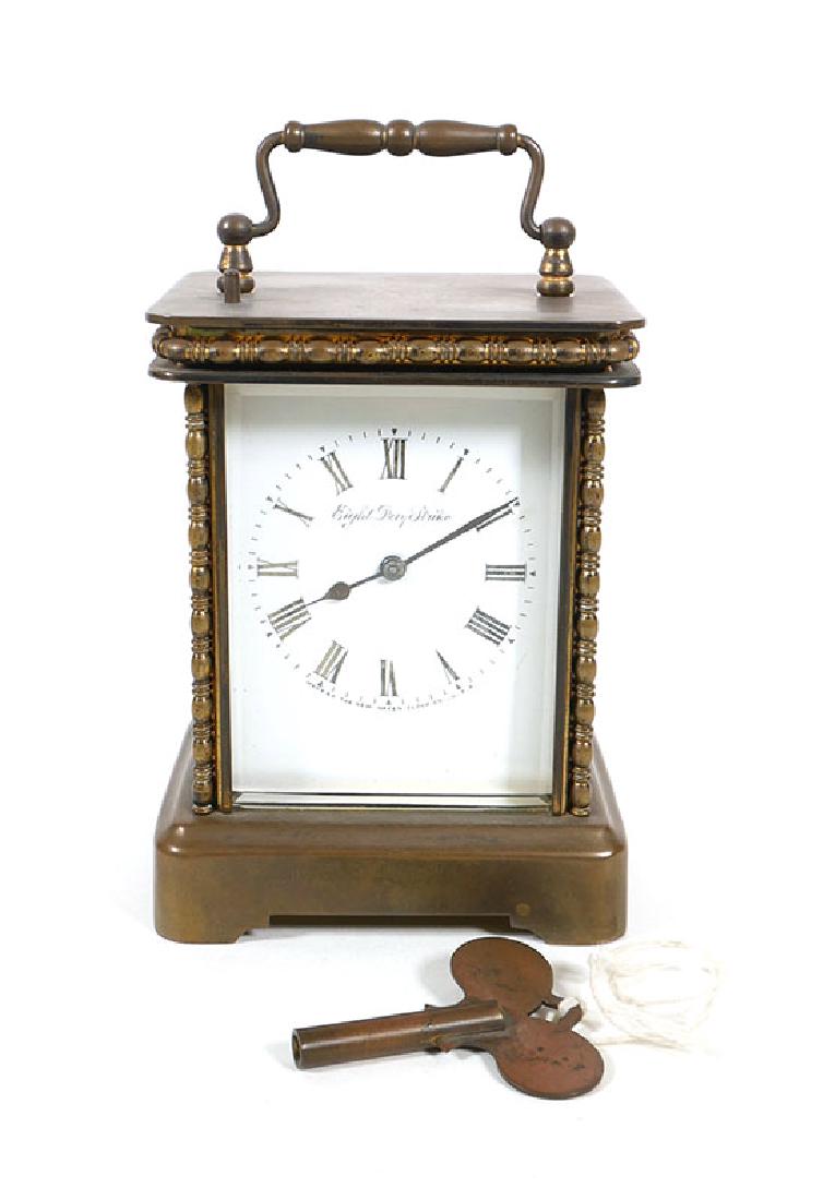 Antique New Haven 8 Day Brass Carriage Clock with Key: Antique brass carriage clock with marked porcelain dial, "Eight Day Strike" and "Made by The New Haven Clock Co. U.S.A." Three beveled glass panels and turned trim detailing. Good condition, corner of