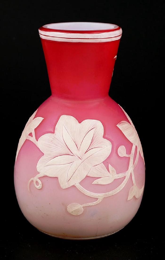 Thomas Webb Carved Cameo Glass Cabinet Vase Signed: Thomas Webb white cameo glass vase with floral and leaf motif on a pink ground. Signed on the underside "Thomas Webb & Sons." Fine condition. Measures 4-3/4" tall.