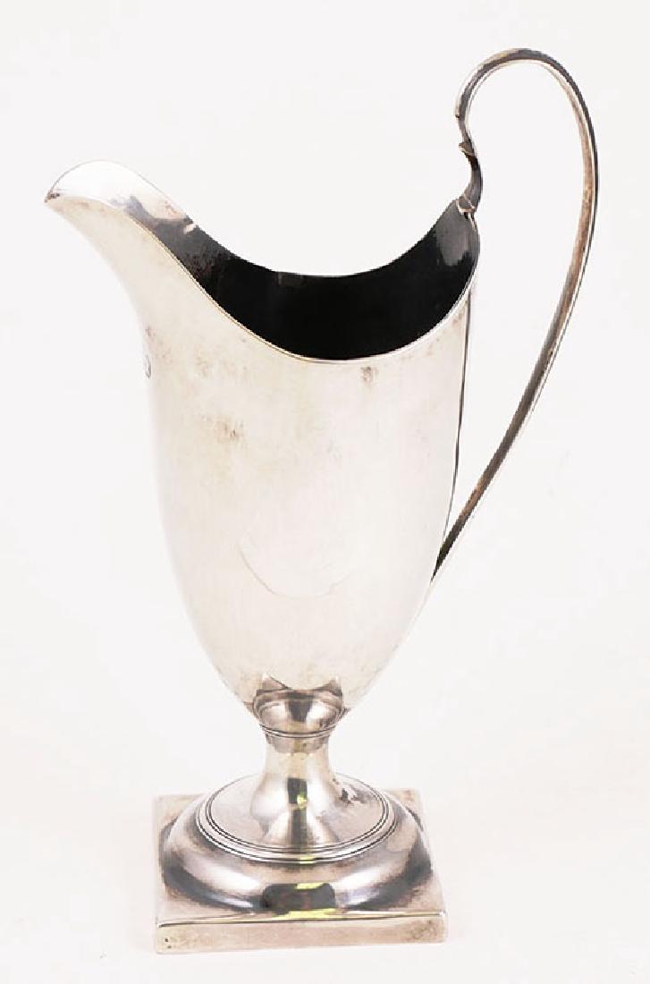 George III English Sterling Silver Cream Pitcher: Georgian period, dated 1786 sterling silver footed creamer, measuring about 6" high and weighing 87.8 grams. Good condition for age, with some touch marks, but no holes or fractures of any kind. No mo
