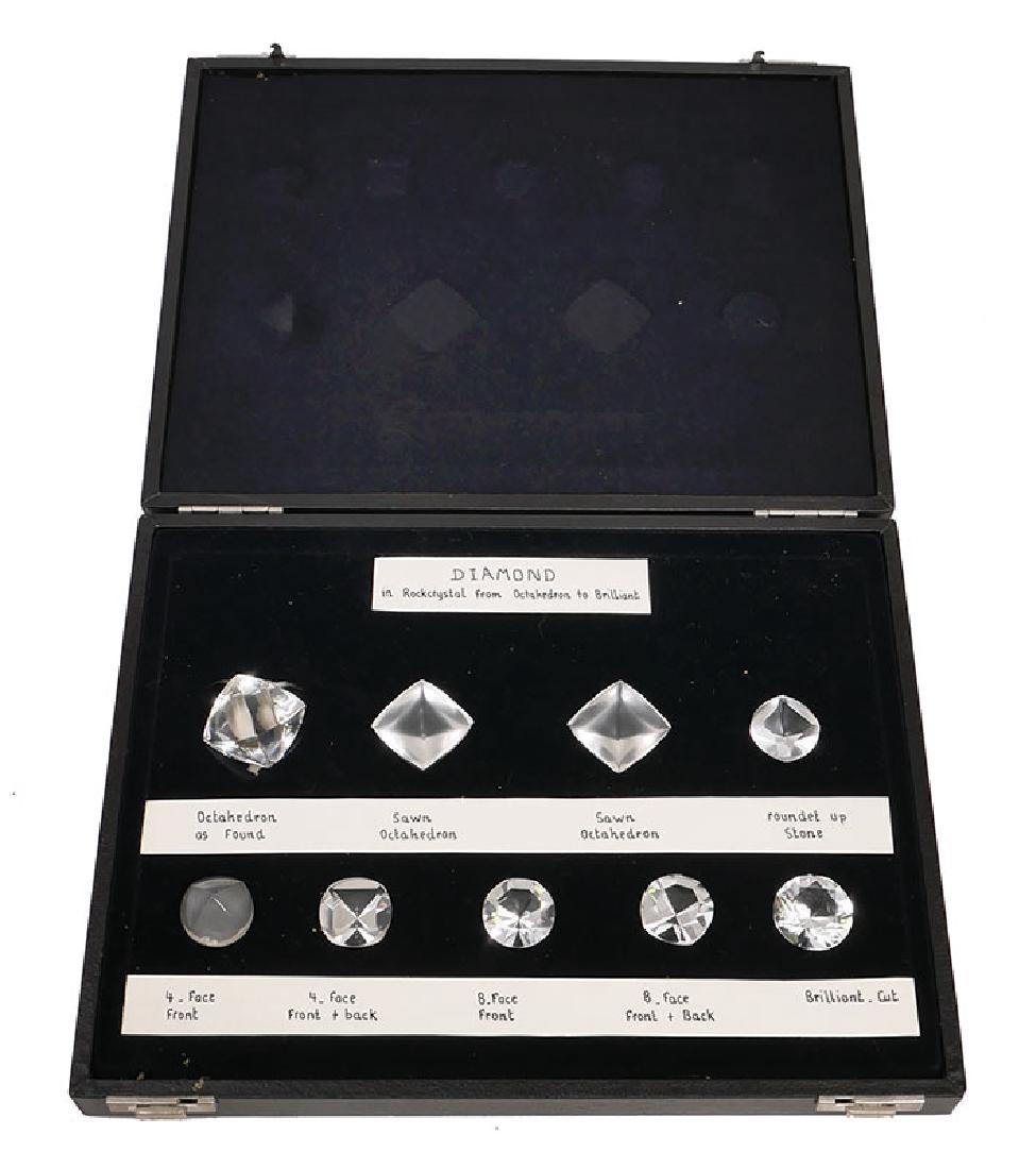Diamond Evolution Collection Museum Display: Fascinating collection in hinged case of rock crystal representations of diamonds, each measuring more than an inch wide, in each state from raw to brilliant cut. Case measures 9" x 11-3/4".