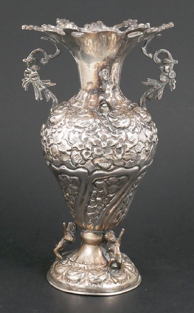 Old Turkish 900 Silver Repousse Figural Vase: Antique coin silver vase, hand-chased repousse with cherubs along base and on each side of handles along shoulder. Measures 8-1/8" high and weighs 12.7 Troy ounces. Signed along base with hallmark.
