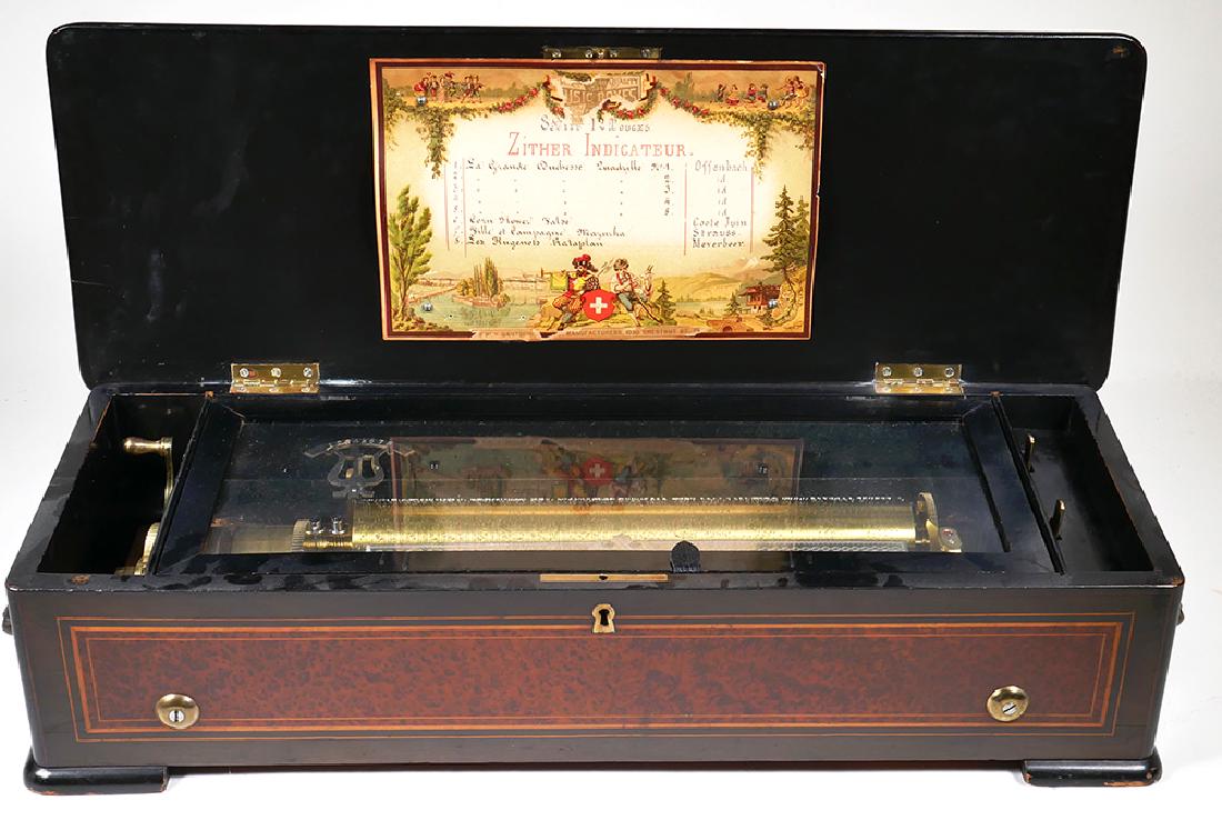 1900 Henry Gautschi Swiss 8-Song Music Box: Gorgeous and fully functional antique Swiss music box. Works are exceptionally clean and undamaged. All teeth intact. One crank and it will begin playing for some time. Measures 25" wide.