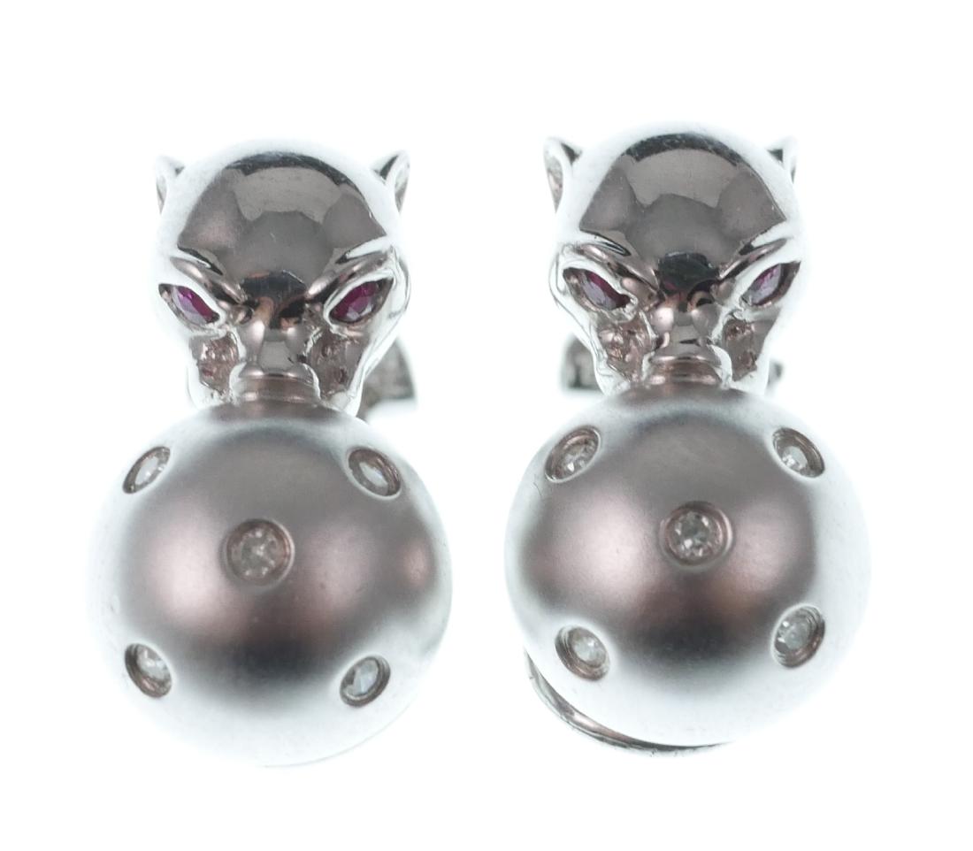 14k White Gold Panther & Ball w Diamonds Earrings: Fabulous earrings in 14k white gold, in the manner of Cartier's iconic panthere motif. Ruby-eyed panthers hold balls with mounted diamonds. Total weight 7.2 grams.