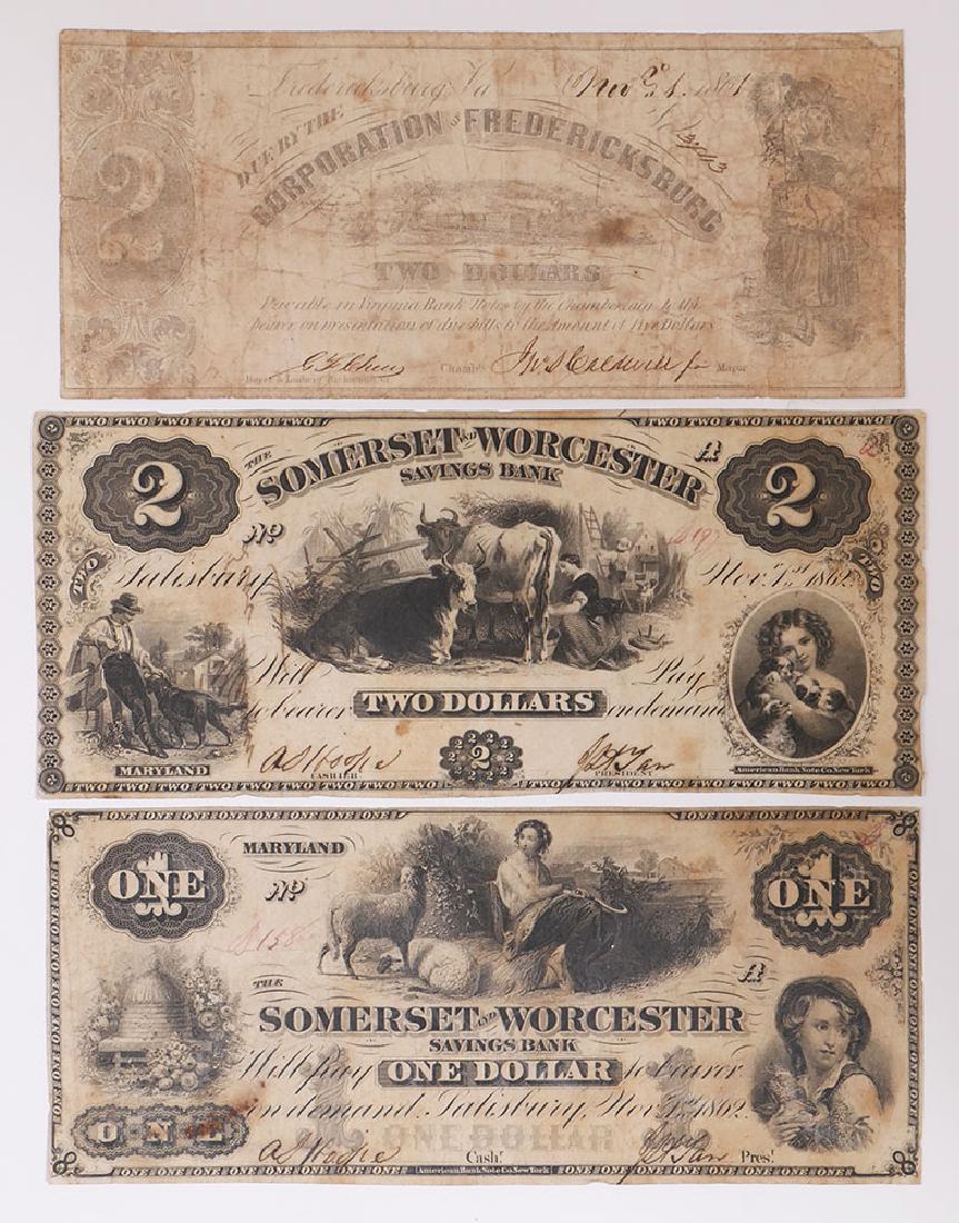 3 Pieces of 1860s Currency Notes: Three notes of 1860s currency including Fredericksburg 2 dollar bill and two 1862 Somerset & Worcester 1 and 2 dollar bills. See photos for condition.