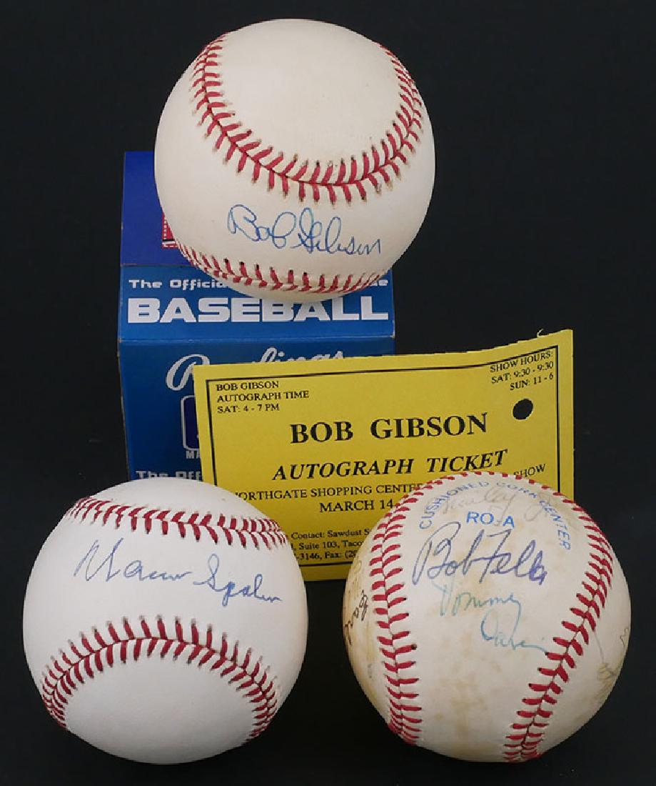 Baseballs Signed by Hall of Fame Pitchers: Three baseballs, one signed by Warren Spahn, one by Bob Gibson, and one signed by several pitchers, including Don Drysdale, Bob Feller, Early Wynn, Mel Stottlemyre and others, 13 in all. Signatures gu