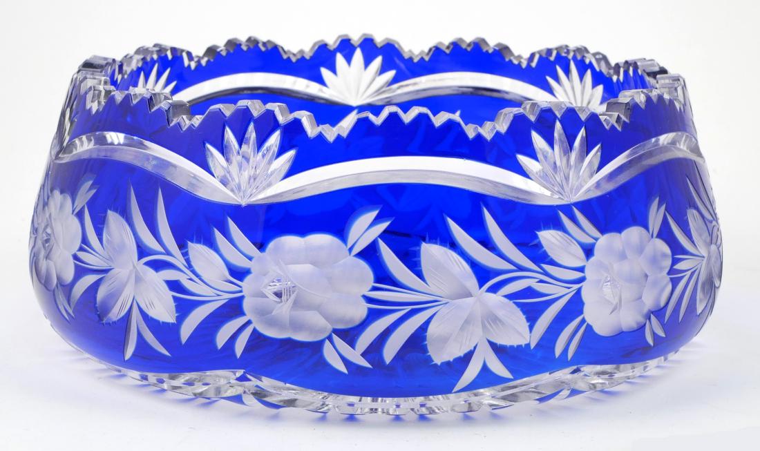 Cobalt Overlay Crystal Centerpiece Bowl: Large cobalt overlay cut glass centerpiece bowl with cut to clear and intaglio floral pattern. Good condition. Measures approx. 4" high x 10" in diameter.