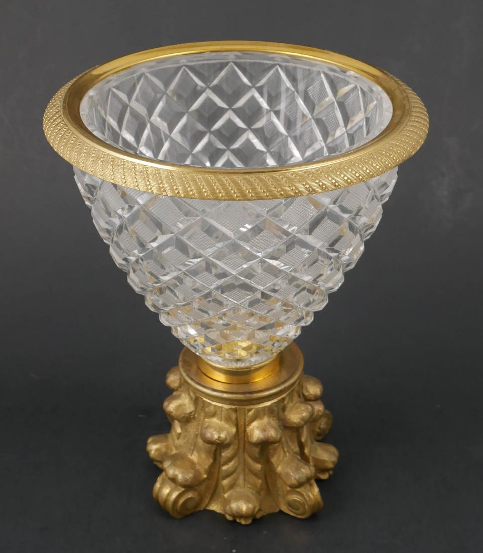 Ormolu Mounted Baccarat Cut Crystal Bowl: Bowl or candy dish with gilt bronze rim and foot, attributed to Baccarat. Measures 7" high.