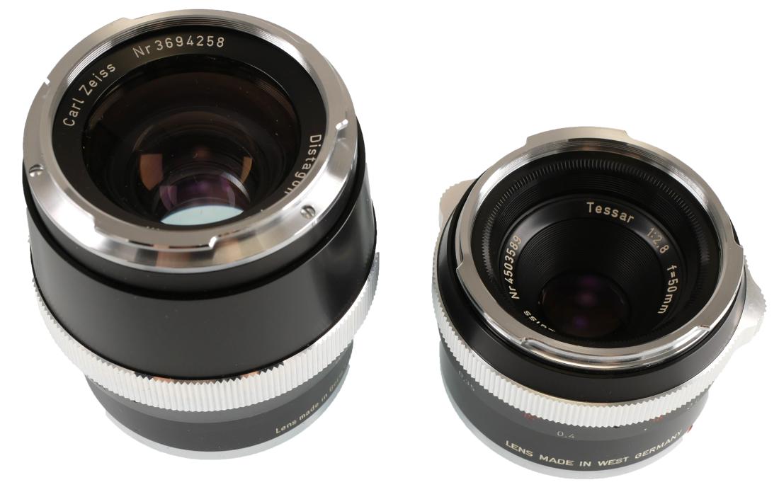 2 Carl Zeiss Lenses, Tessar & Distagon: Two vintage lenses, including Carl Zeiss Distagon lens, 1:2 f=35mm with serial number NR3694258 and Carl Zeiss Tessar 1:2.8 f=50 with serial number Nr4503589. Cases included.