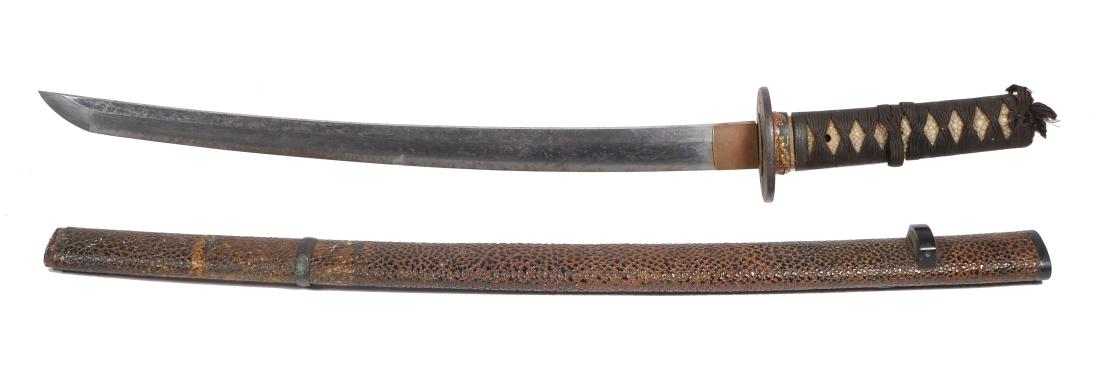 Japanese Wakizashi Yoshiyuki 17th Century: Antique Japanese short sword bearing the mark of 17C swordmaker Yoshiyuki. Inscription reads "Yamashiro Daijo Fujiwara Yoshiyuki." Measures 29" overall in scabbard. Cast iron tsuba appears to be appro
