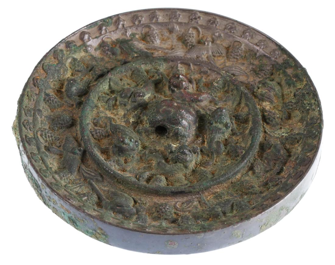 Very Old Ornate Chinese Bronze Mirror: Measures 5" diameter. High relief designs on one side. Center design, which appears to be an animal of some sort, was made with a hole through it, presumably for a hanging cord.