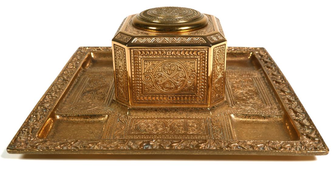 TIFFANY VENETIAN Gilt Bronze Inkwell: Bronze Tiffany desk set covered inkwell in the "Venetian" pattern. Measures 9-1/4" x 9-1/4" x 4" tall. Invicta coated. Circa 1920s. Tiffany Studios, New York mark under base. Many other pieces from th