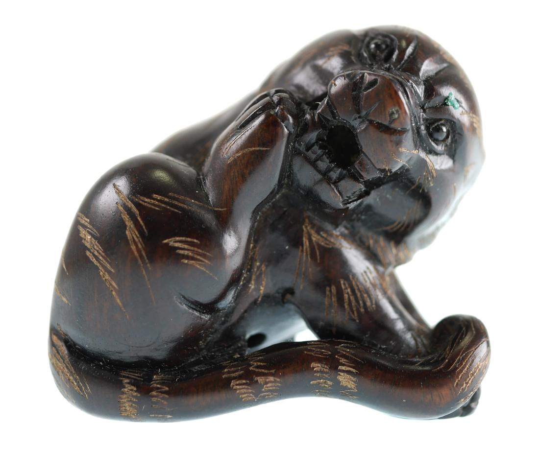 Signed Japanese Boxwood Tiger Netsuke: Ebony or boxwood carved Japanese miniature figure of a tiger. Measures about 1-1/2" high.