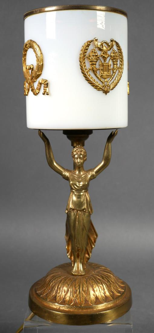 French Art Glass Figural Ormolu Boudoir Lamp: Fine vintage table lamp, measuring about 11-1/2" high, with thick white glass shade decorated with bronze ormolu wreaths. Held aloft by woman figure on acanthus base. European plug (should be rewired 