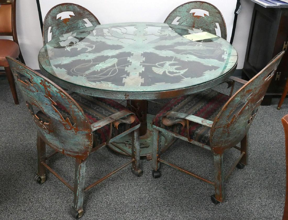 Native American Wrought Iron Table & Chairs: Contemporary Colorado Indian motif table and chairs, heavy wrought iron with verdigris and rust coloring, openwork with glass top. Artist Tom McCall. (Chairs have rolling wheels that were added to the