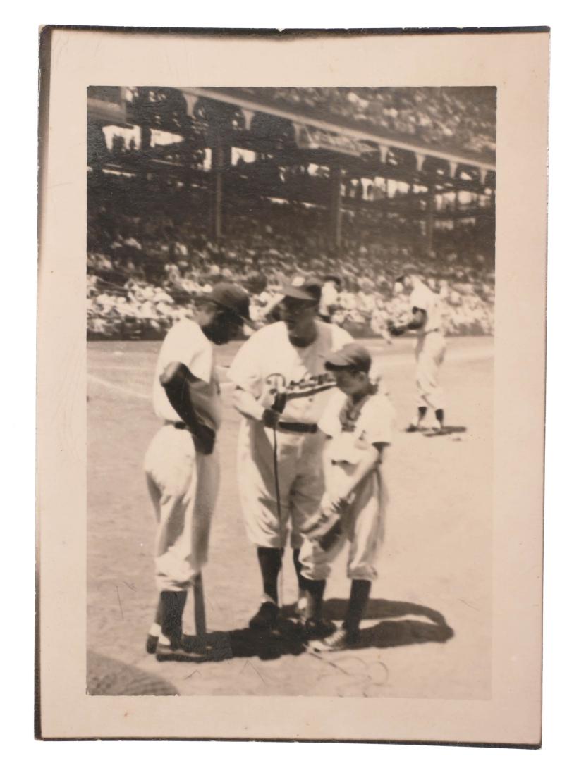 PHOTO: Jackie Robinson Brooklyn Dodgers Candid: Candid photograph of HOF Dodger Jackie Robinson talking with a young boy with someone presumed to be an announcer. Measures about 3-1/2" x 2-1/2". Never before published.