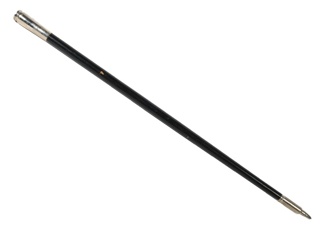101st Airborne Division Swagger Stick: Vintage swagger stick with a bullet-shaped tip and shell casing shaped pommel, topped with an enameled 101st Airborne screaming eagle patch pin. Measures 18" long. (From the estate of Col. Kenneth R. 
