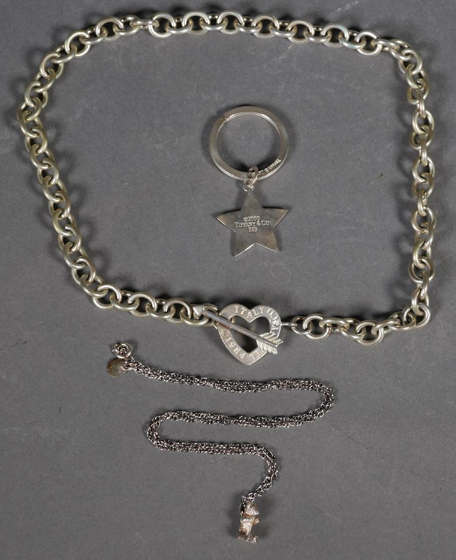 Tiffany & Co Sterling Bear Necklace Star Keychain: Tiffany & Co Sterling teddy bear with articulated arms necklace approx. 17 1/2" with pouch & box & 2000 5 point star keychain with pouch.