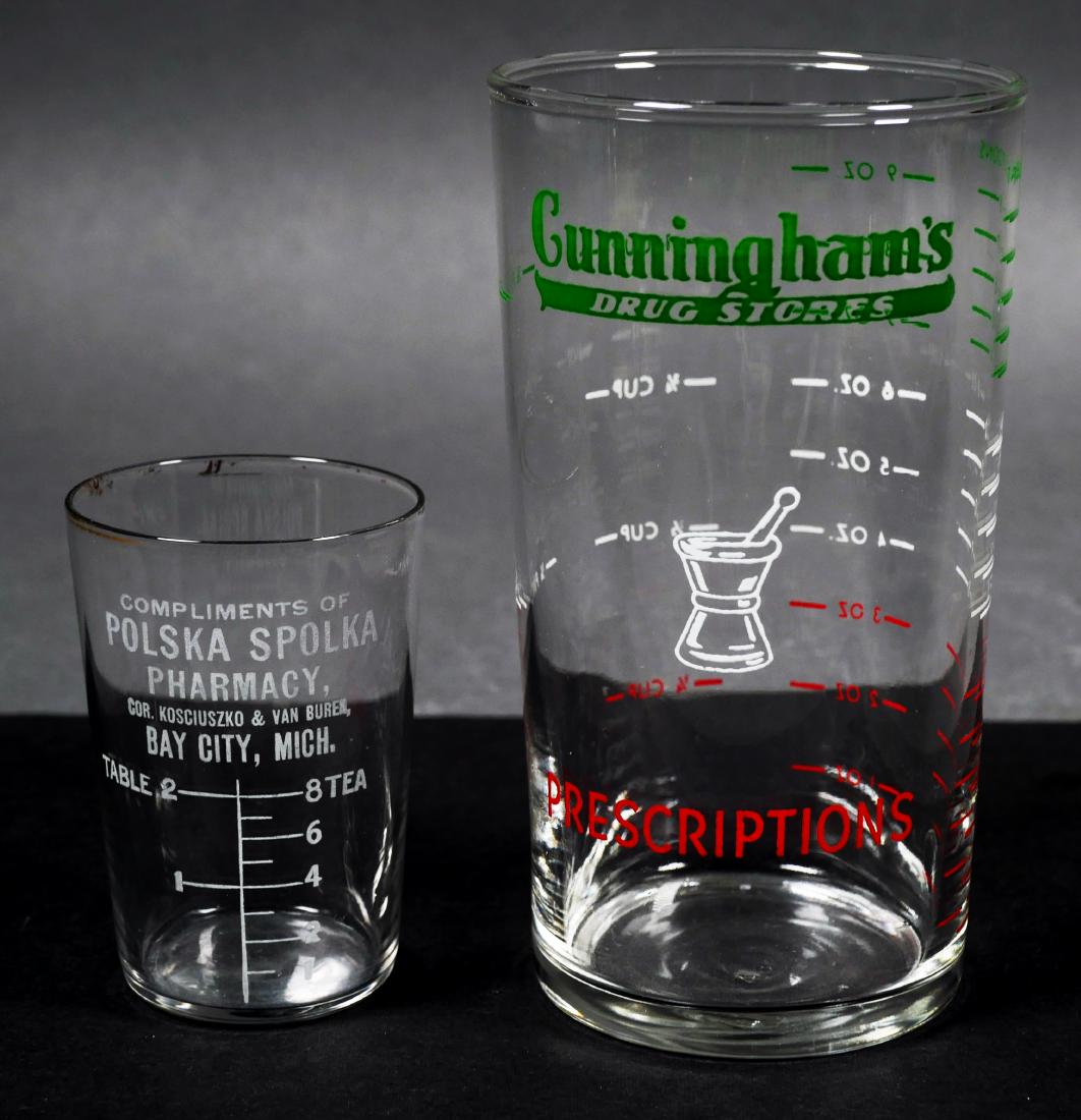 Two Old Drugstore Glass Advertising Items: 1940s glass tumbler with logo for Cunningham's Drug Stores. Measures 4-7/8" high. And a circa 1920 shot-sized measuring beaker from Polska Spolka pharmacy, measuring 2-5/8" high. Both in good conditio