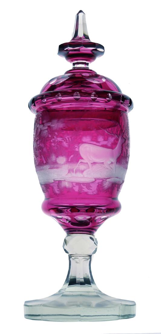 2 MOSER Cut to Clear Lidded Pictoral Jars: Matched pair of ruby cut-to-clear lidded and footed vessels, attributed to Moser. High-quality intaglio depiction of forest scenes with deer. Each measures about 13-3/8" high. Bases have shelf wear. N