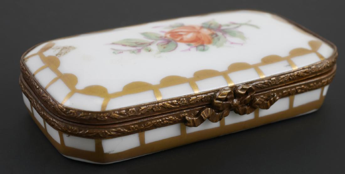 Erotic Limoges Box: Rectangular hinged limoge box with hand painted erotic scene under lid, along with flowers. Measures 1 1/2" x 3".