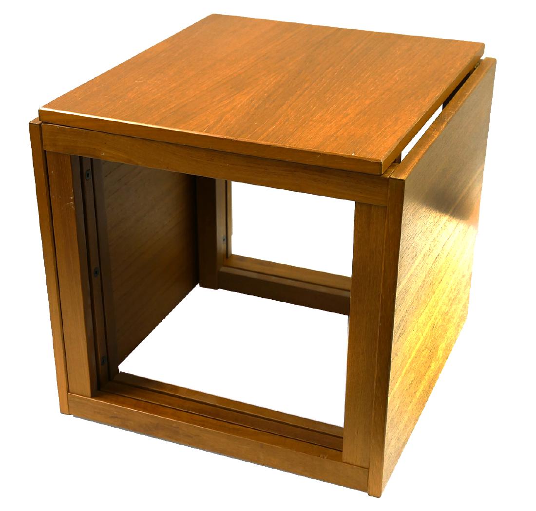 (3) Mid-Century Modern Teak Nesting Tables: Set of three mid-century teak nesting tables. Unusual configuration where nested tables lay on sides. Unsigned. Each table measures 17 3/4" x 15 3/4" x 16 1/2".