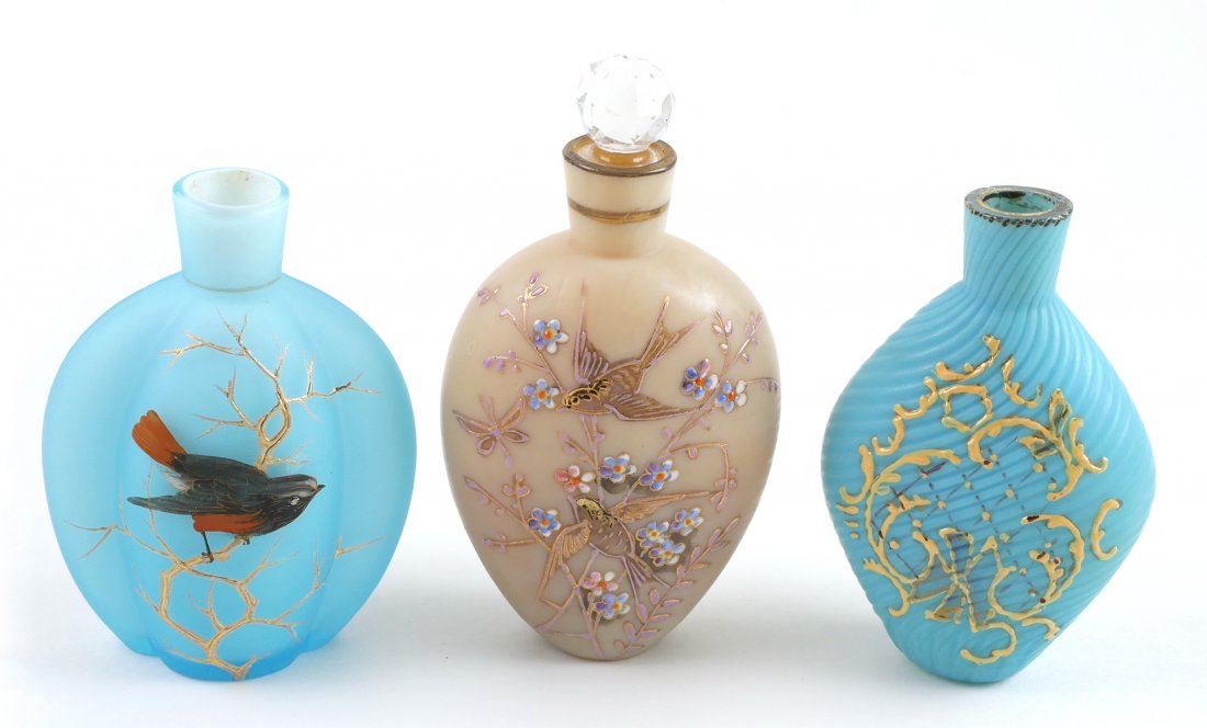 THOMAS WEBB Three Glass Perfume Bottles: Antique art glass perfumes, enamel decorated, attributed to Webb. One has a stopper. Blue bottle decorated with bird is cased. Each measures about 3-1/2" to 4" high. Excellent condition.