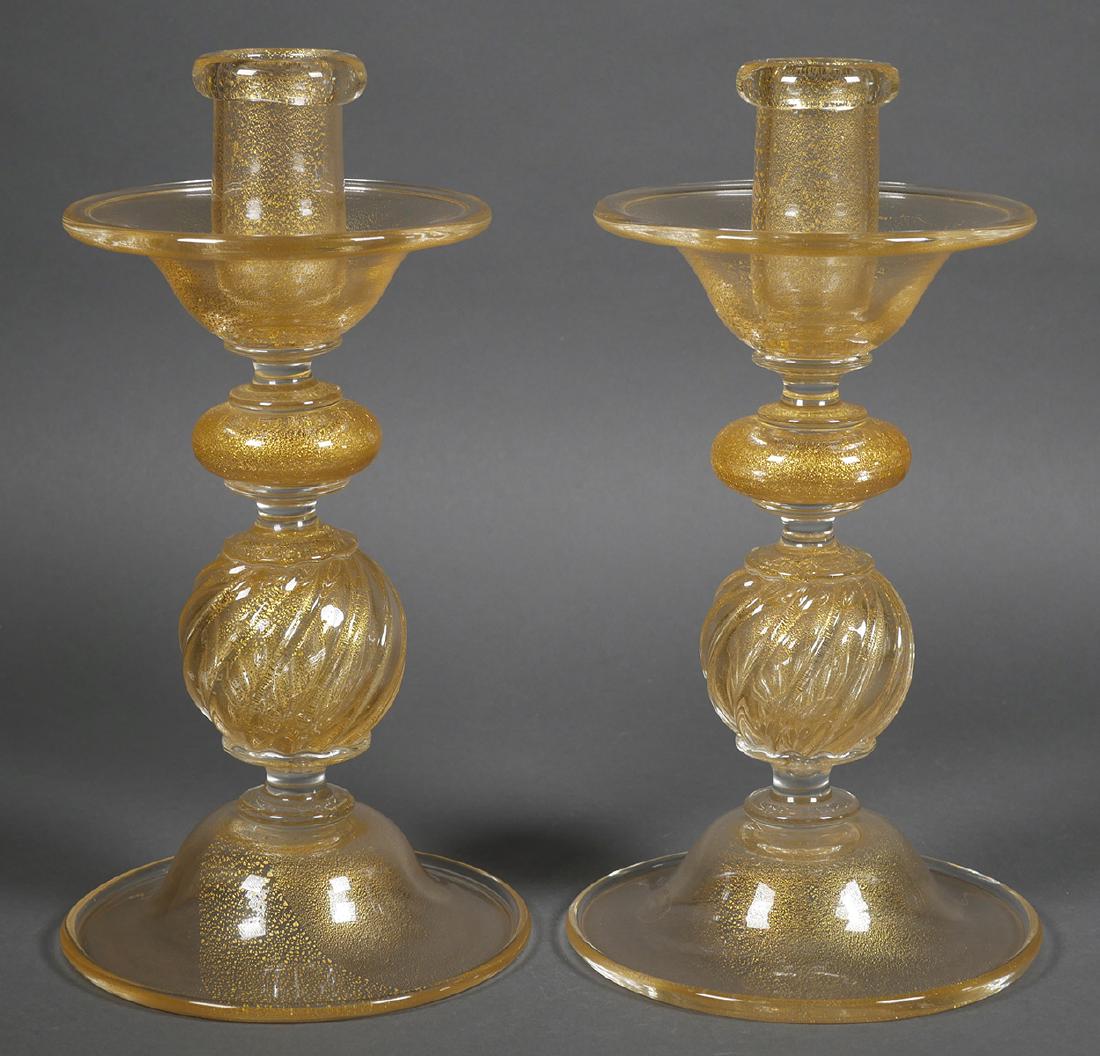 ARCHIMEDE SEGUSO Aventurine Murano Candlesticks: Matched pair of blown glass candlesticks in gold aventurine glass. Signed Seguso Murano with original label affixed. Each measures 11" tall.