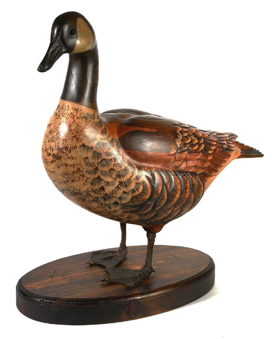 TOM TABER, Carved Wooden Goose: Life-sized carved wooden goose by renowned carver Tom Taber. Painted wooden body with bronze feet. Signed on the base by Tabor and John Fairfield. Overall height with base is 21 1/2".
