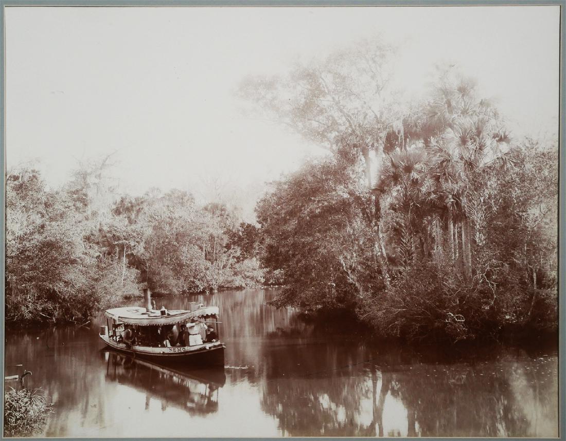 WILLIAM HENRY JACKSON, Florida Steamboat Photo: Sepia tone enlargment photograph of a steam powered tour riverboat named NEMO, on "The Tomoka, Near Ormond Florida." The man who appears to be the guide is standing at the front of the boat pointing a