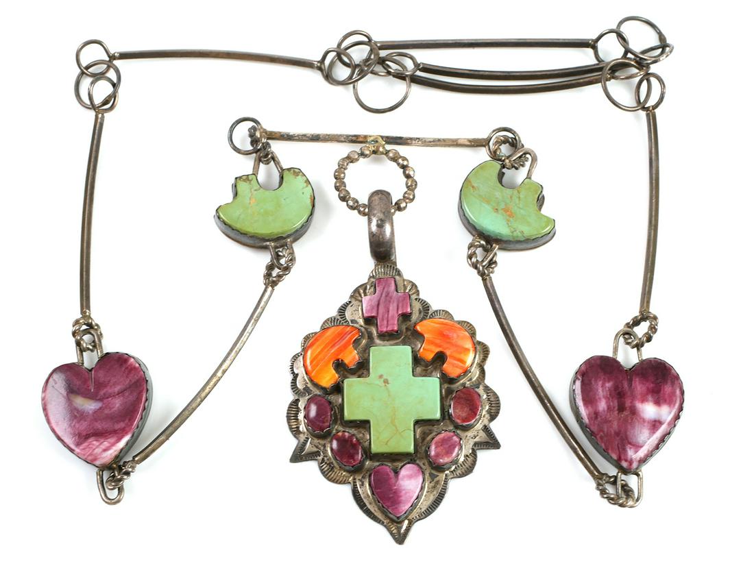 Navajo Sterling Trade Necklace, Signed: Sterling Native American necklace with large central pendant. Somewhere between a trade necklace and a squash blossom. Semi-precious stones in the shape of crosses, bears and hearts on the pendant and