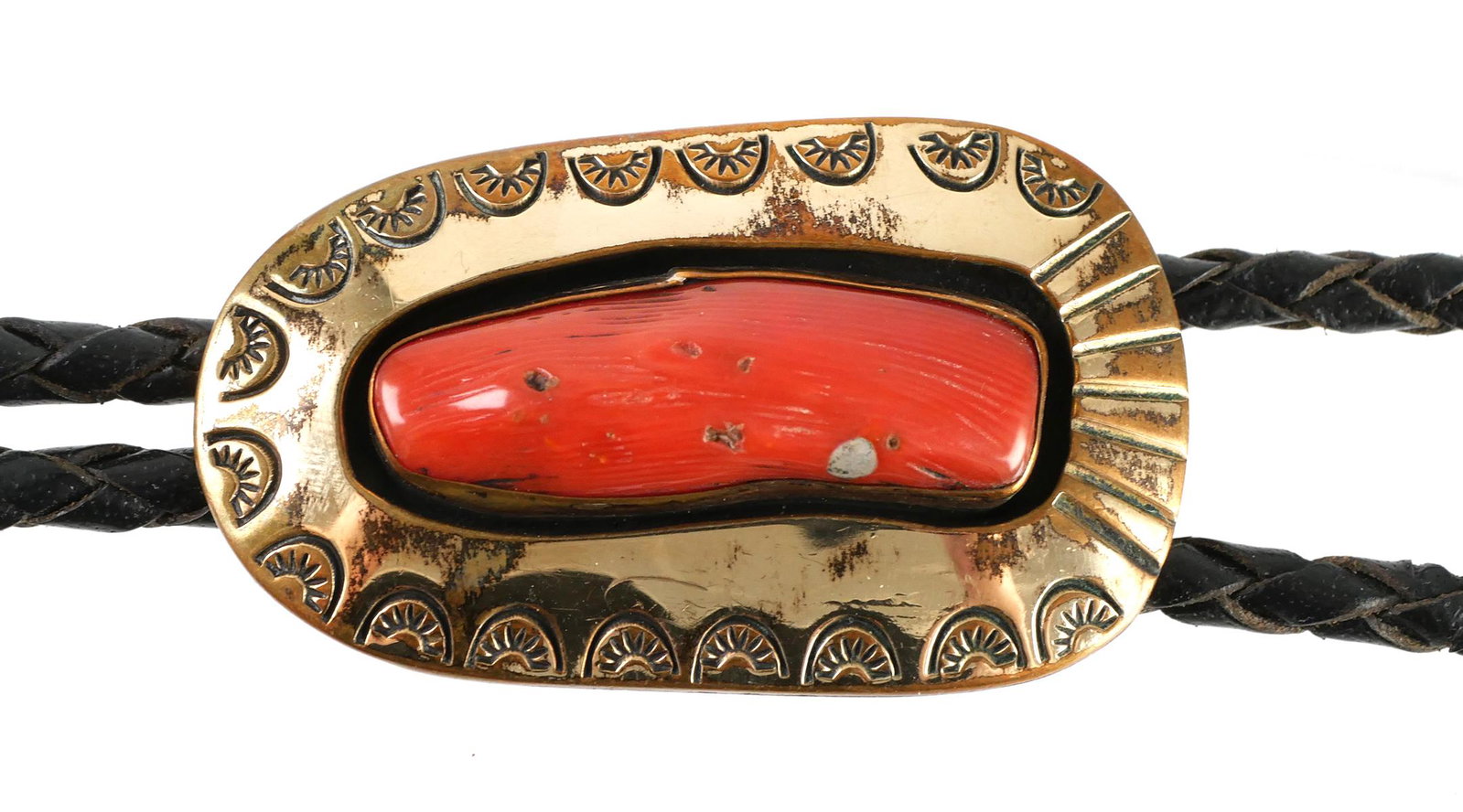 Navajo Gold Vermeil Coral Bolo Tie: Signed in bear claw stamp with LT, this tooled vintage bolo tie appears to be gold plated over what is presumed to be sterling. Old price mark on back ($745) from retailer. Measures 2" long.