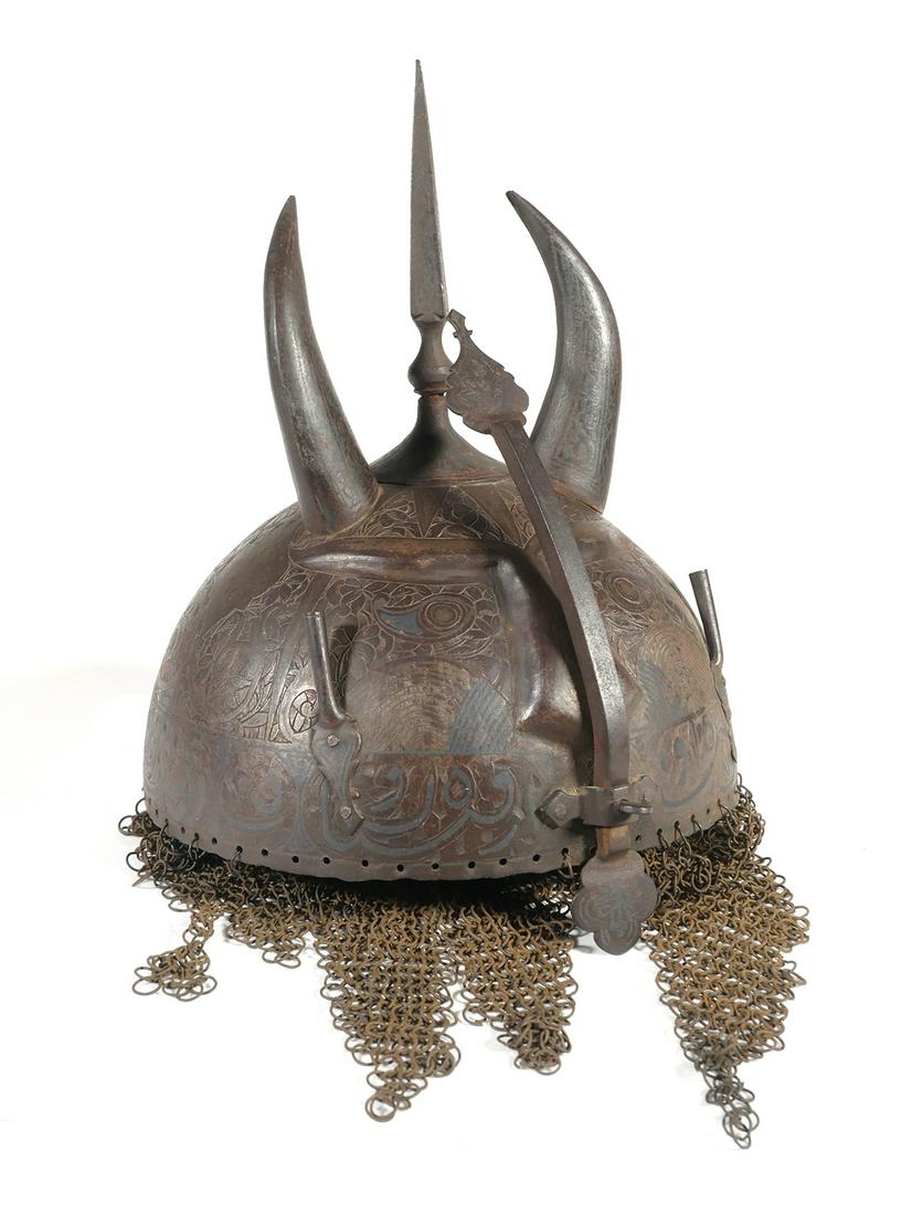 Indo Persian Khula Khud Devil Mask Helmet: Known as a "khula khud," or devil mask, this helmet likely dates from the 18th to 19th century, possibly earlier. Ornate (but difficult to photograph the designs), with set screw adjusted nose guard a